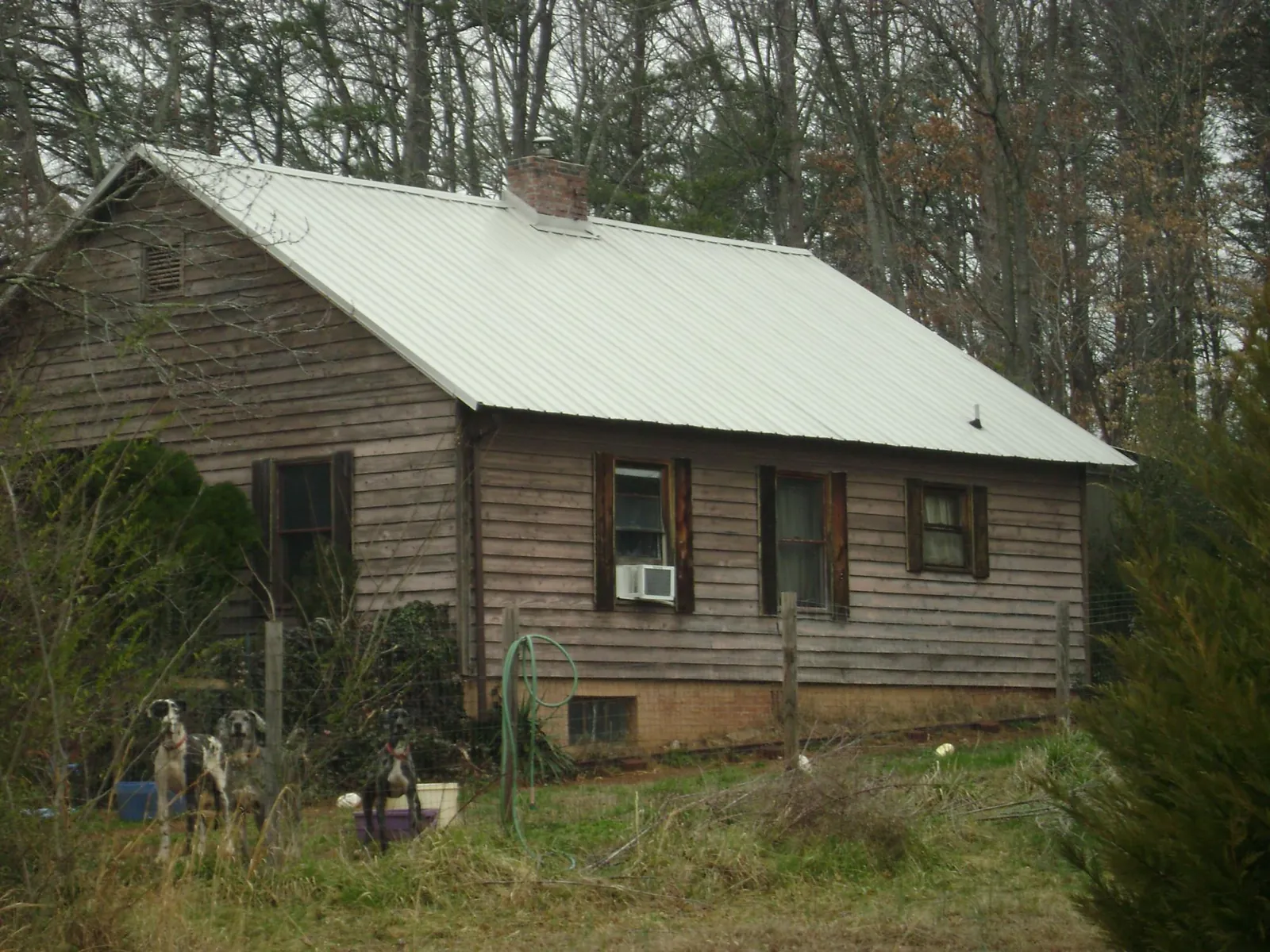 White metal roof on an old wood sided farmhouse, from a Metal Roof Installation job in Loudon